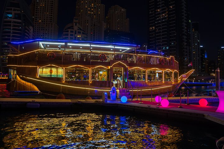 Experience a unique journey through Dubai Marina showcasing stunning architecture luxurious yachts and delightful dining on a beautifully illuminated dhow perfect for unforgettable memories and scenic views.